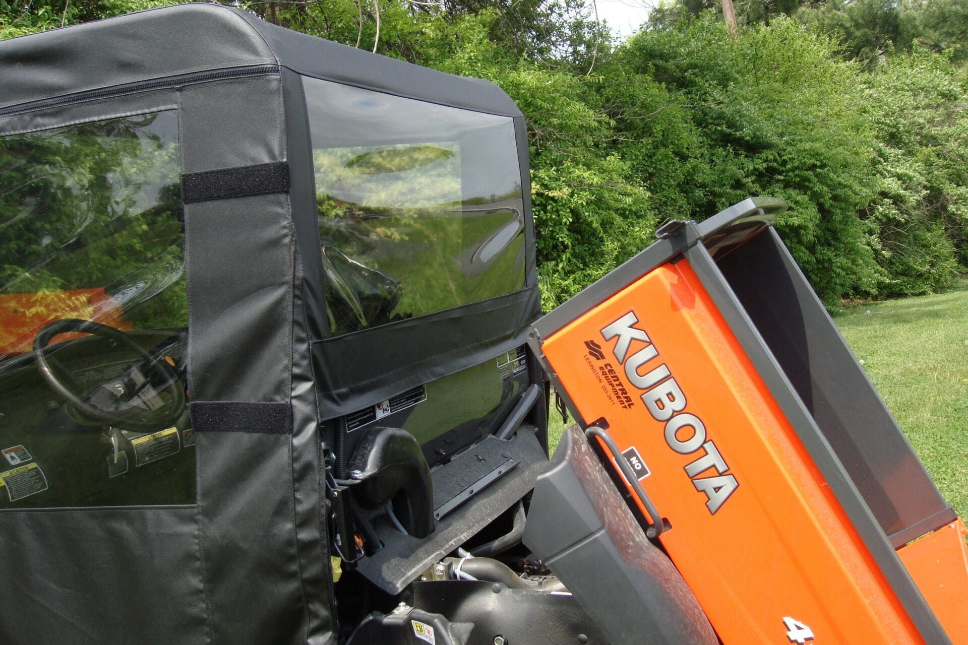 Orange Kubota utility vehicle with tilted bed