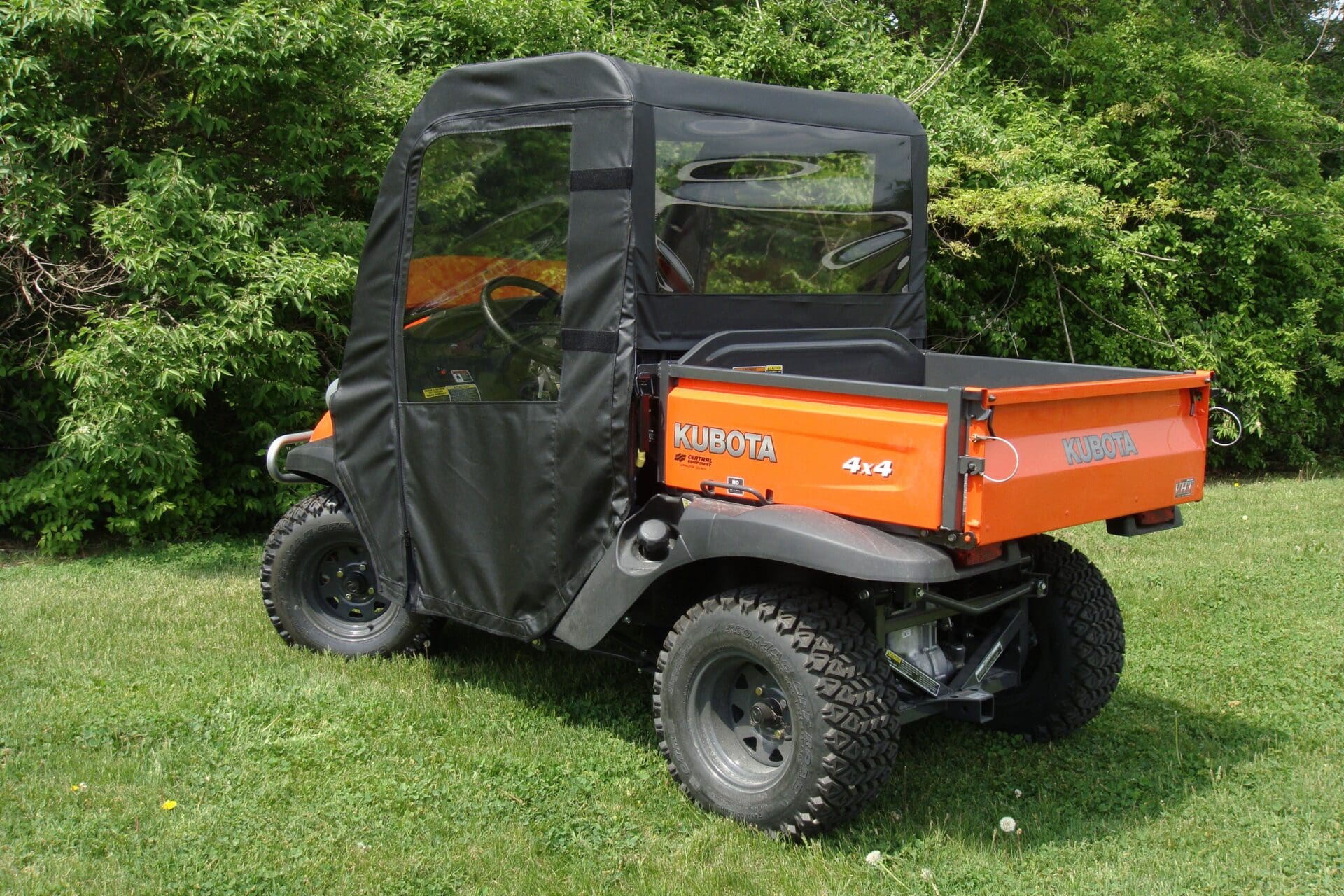 Orange Kubota 4x4 utility vehicle on grass