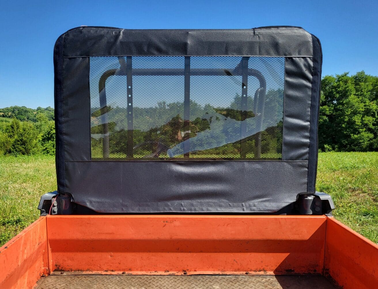 Orange utility vehicle cargo bed with mesh window