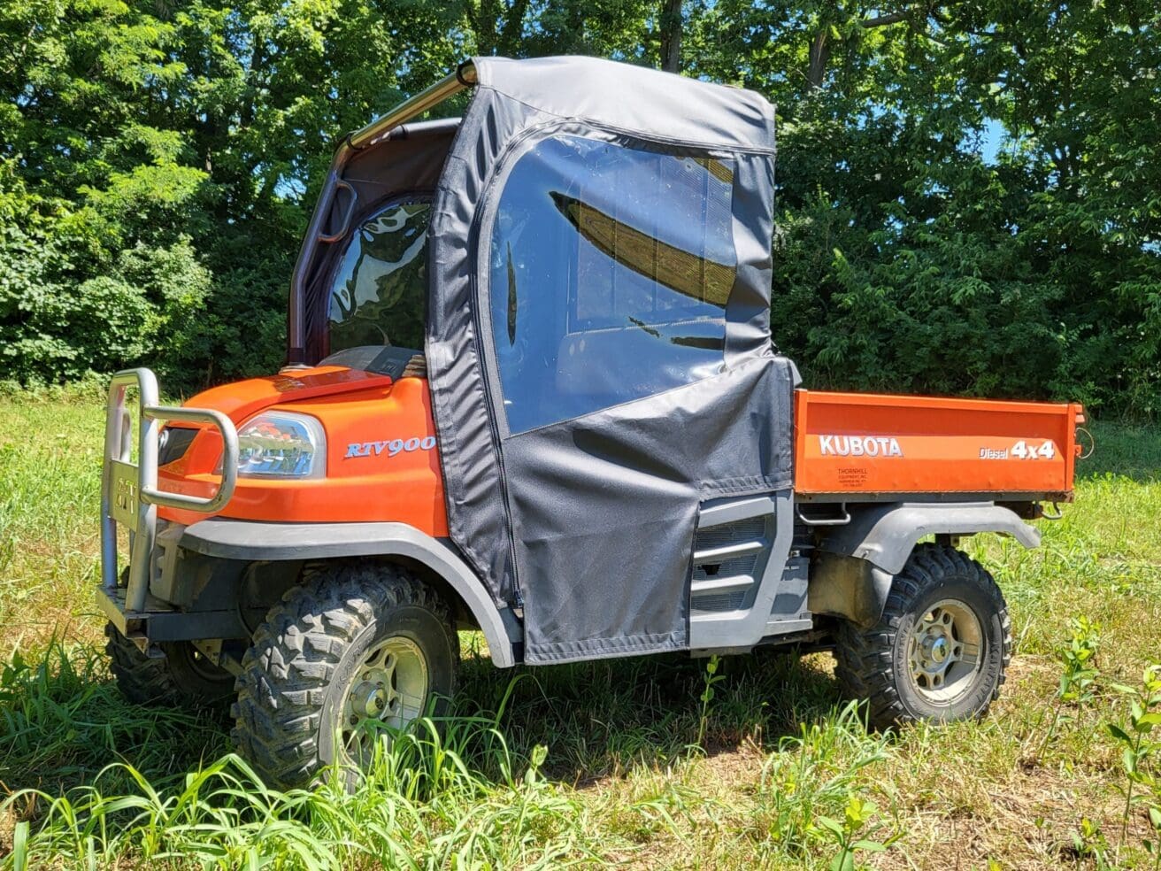 Orange Kubota RTV utility vehicle with enclosure