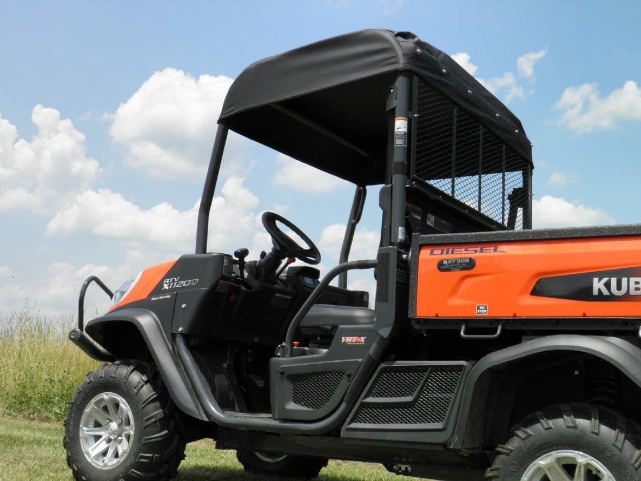 Orange Kubota diesel utility vehicle on grass