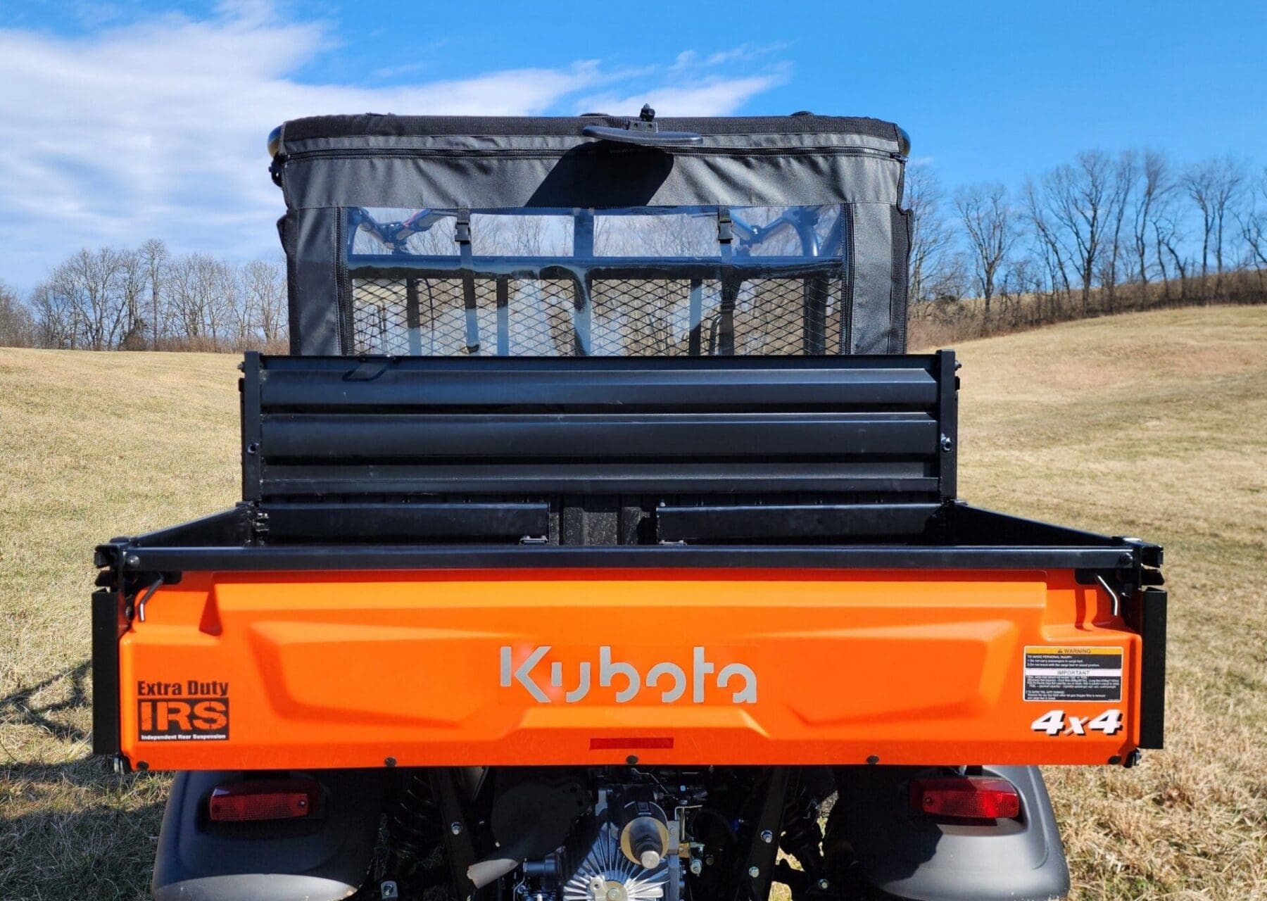 Kubota utility vehicle with black enclosure.