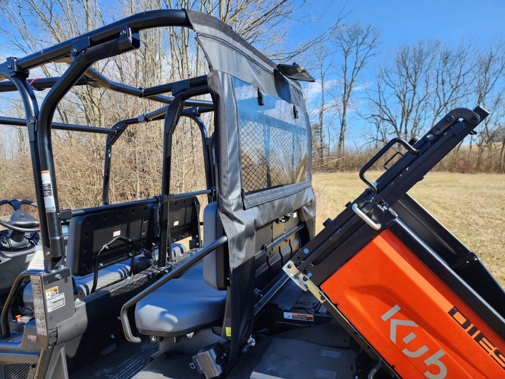 Utility vehicle interior with zippered side panel.