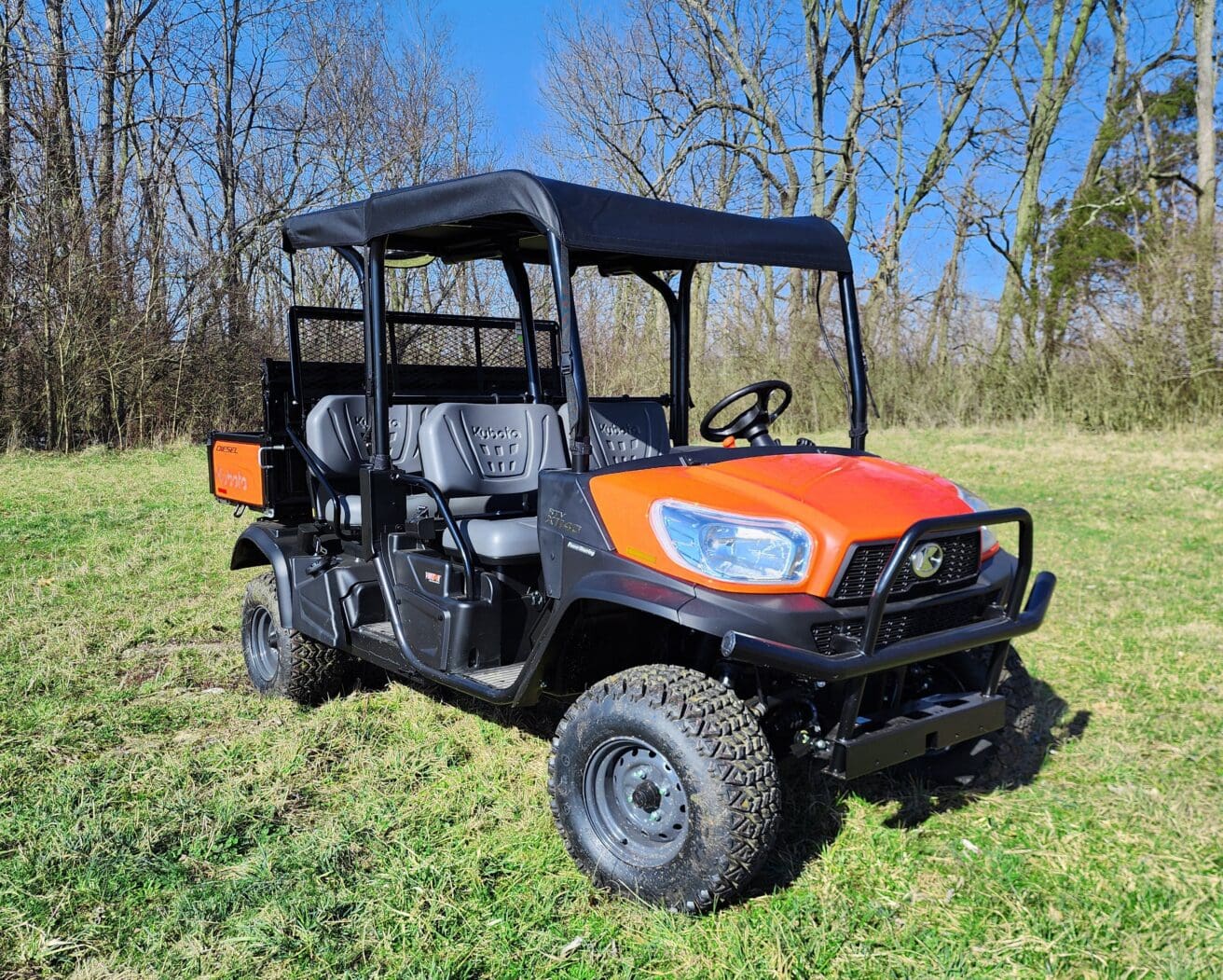 Orange utility side-by-side UTV on grass