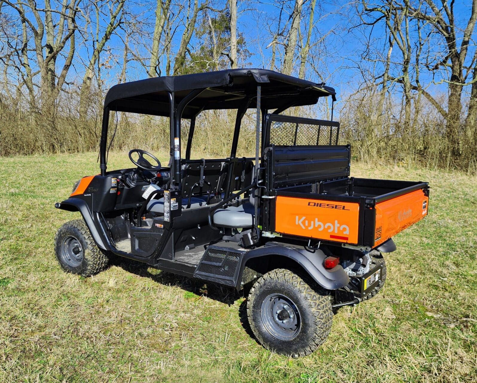 Orange Kubota diesel utility vehicle in field