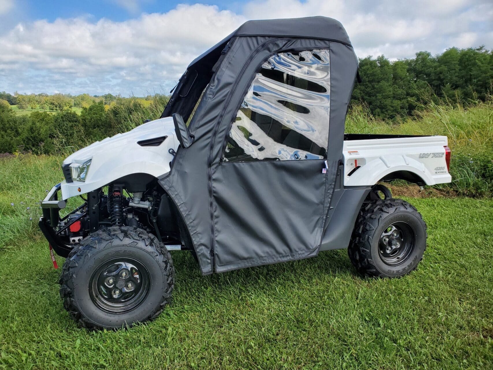 Utility vehicle with soft cab and enclosure.