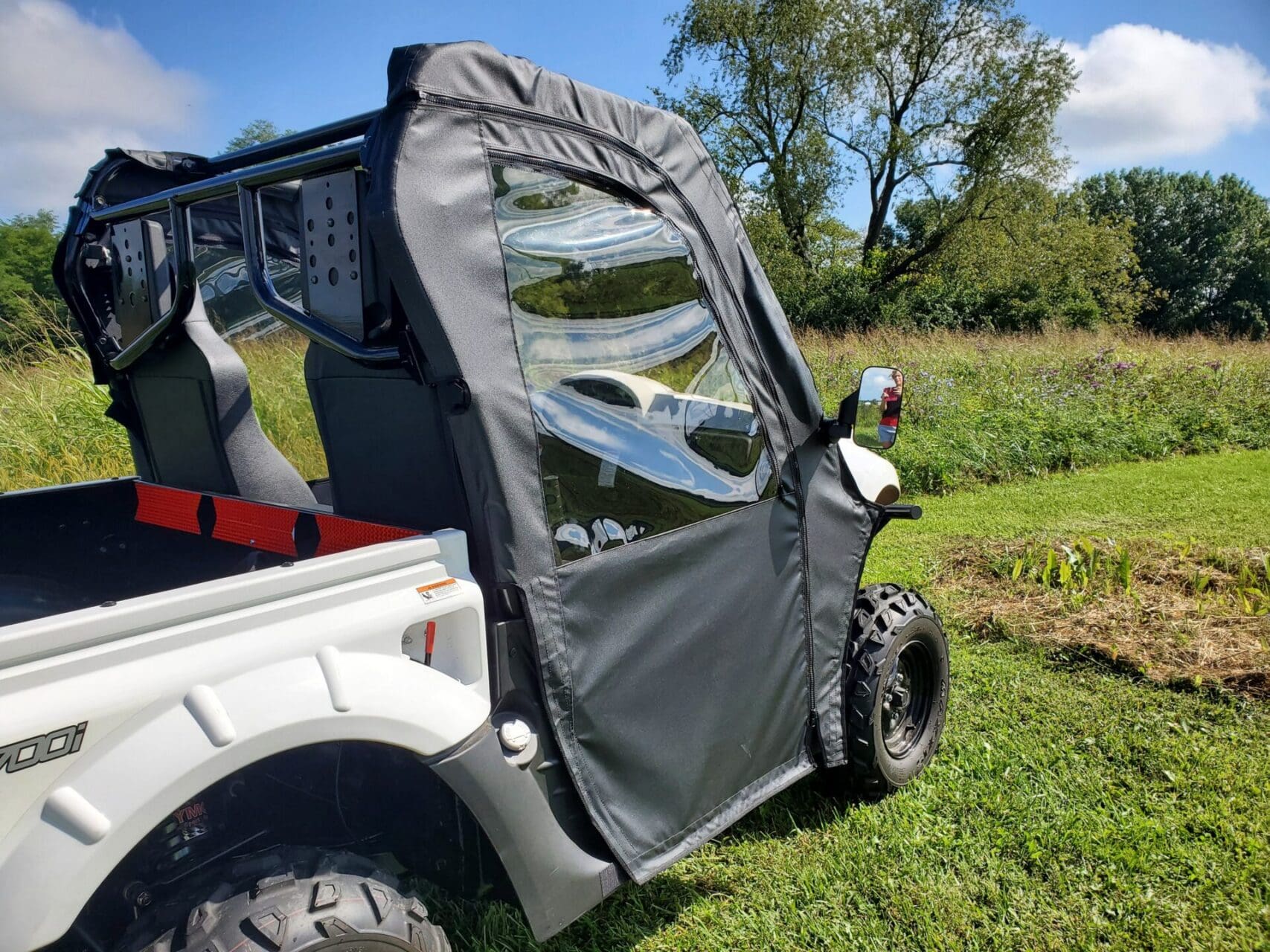 Zippered side enclosure on utility vehicle.