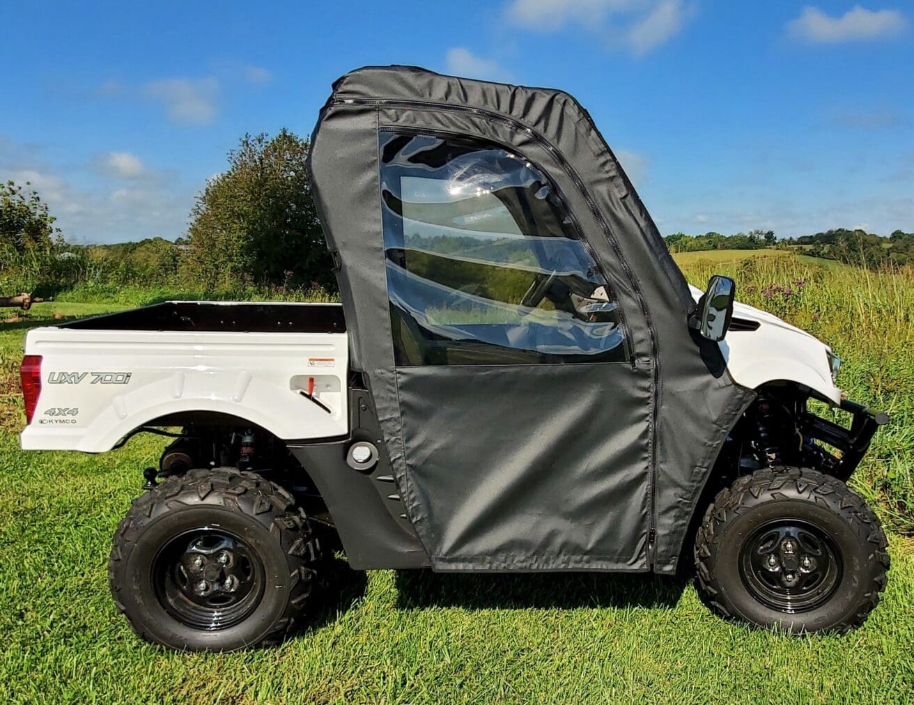 Utility vehicle with soft cab and windows.