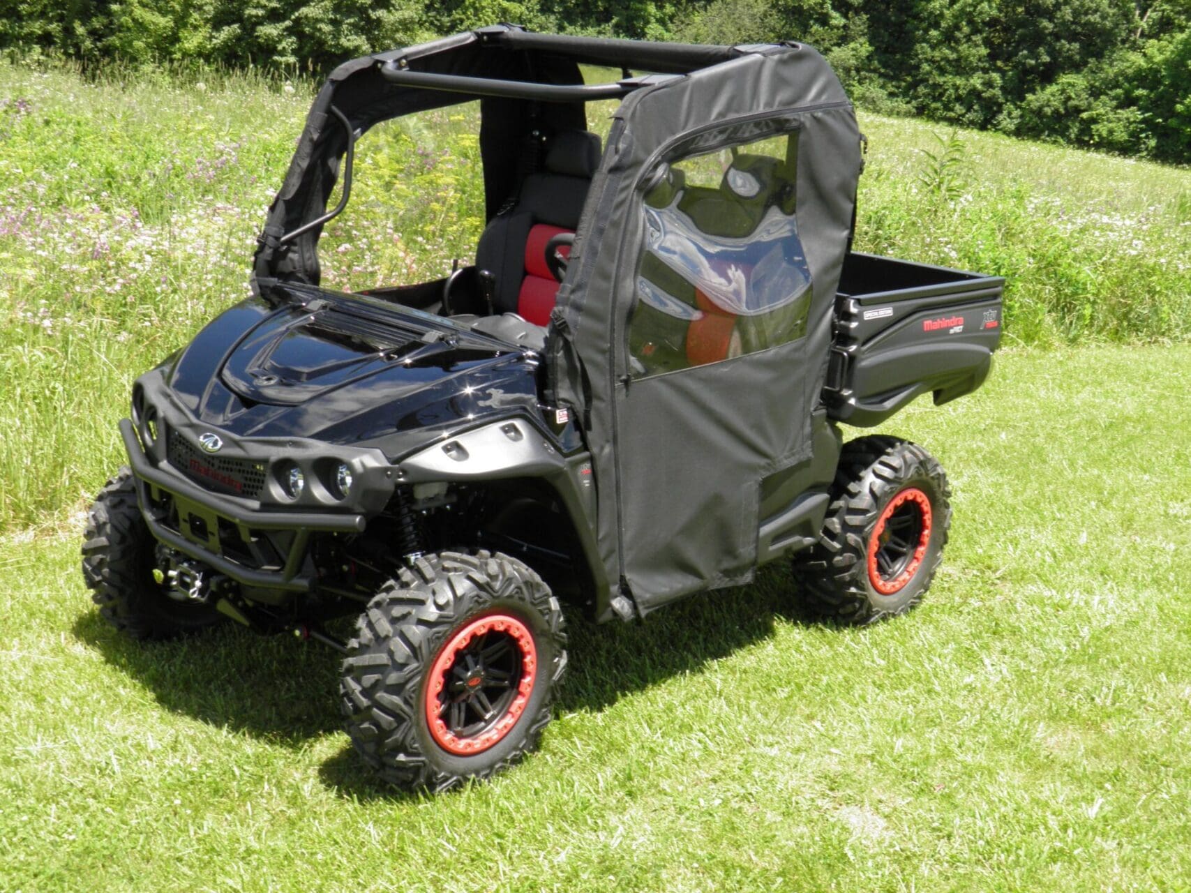 Black utility vehicle with soft fabric enclosure.