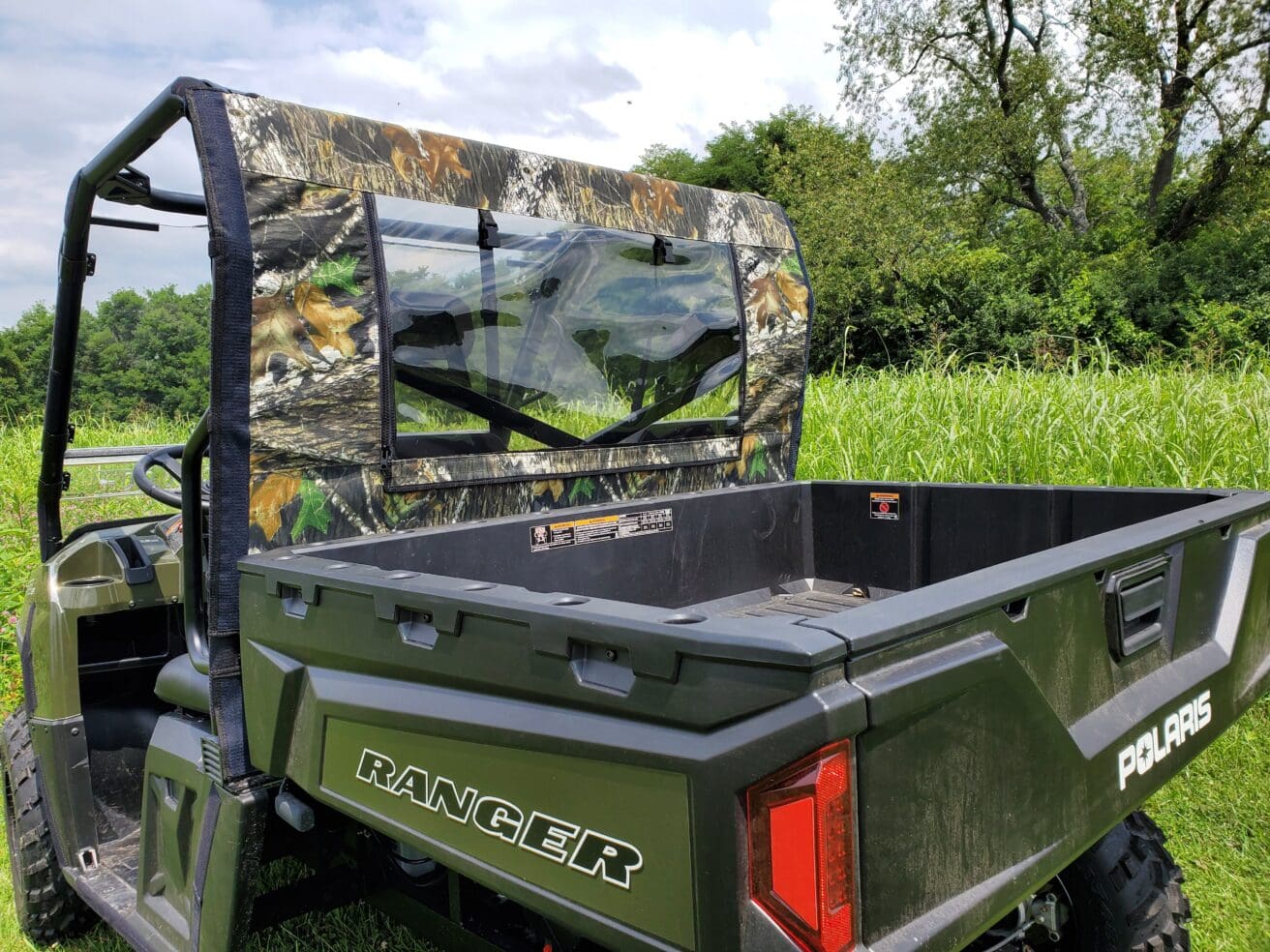 Camouflage soft top with clear rear window.