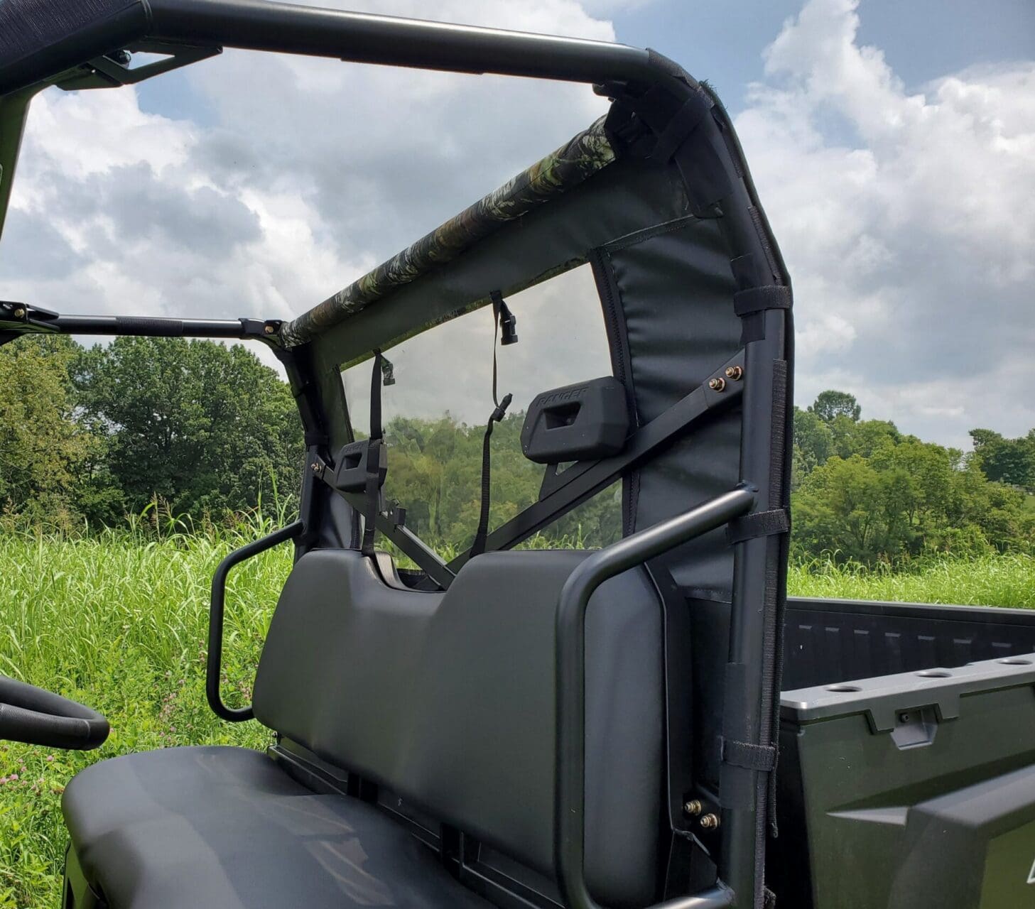 Utility vehicle with soft top and seating.