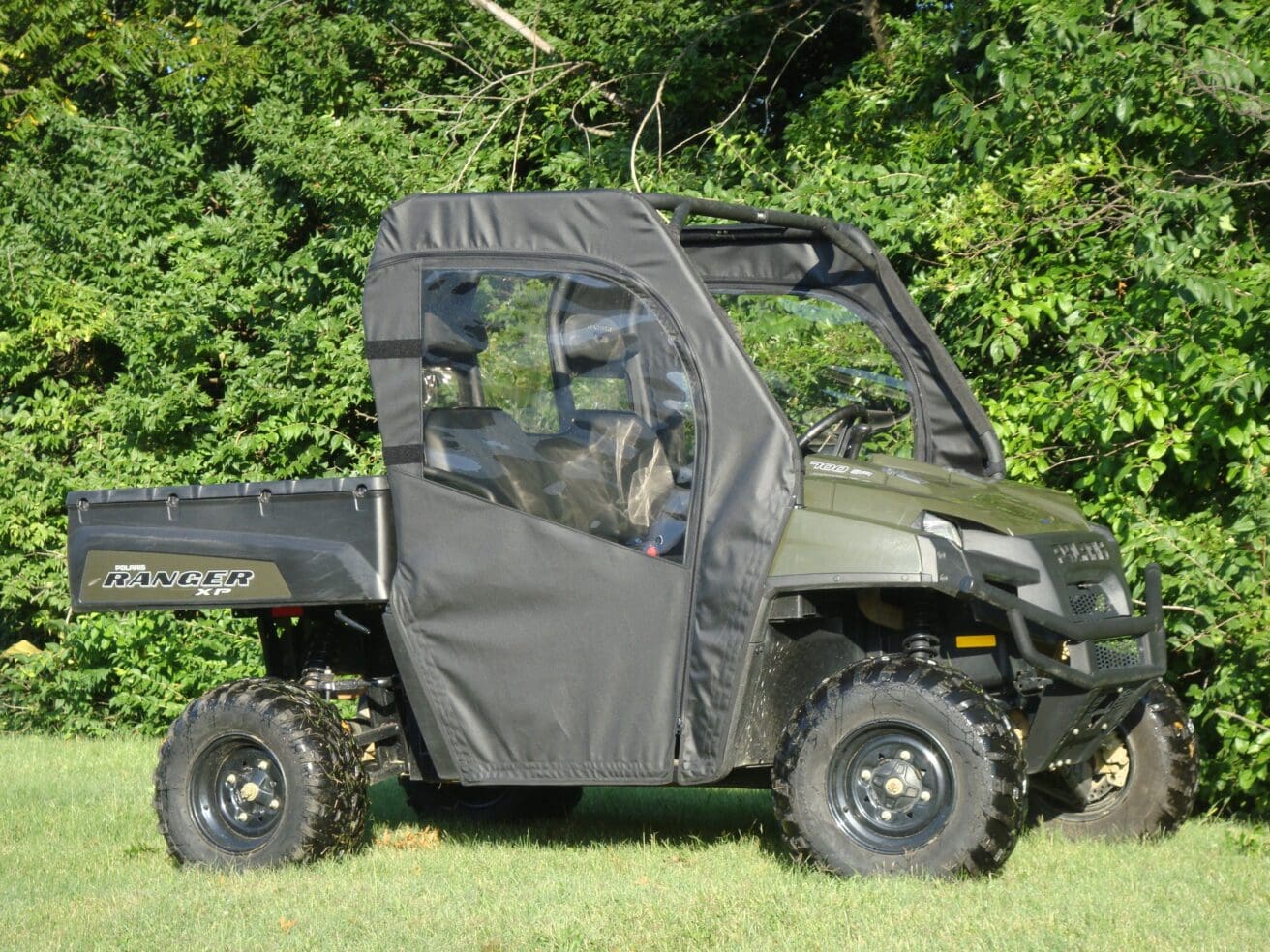 Green utility UTV with soft cab enclosure