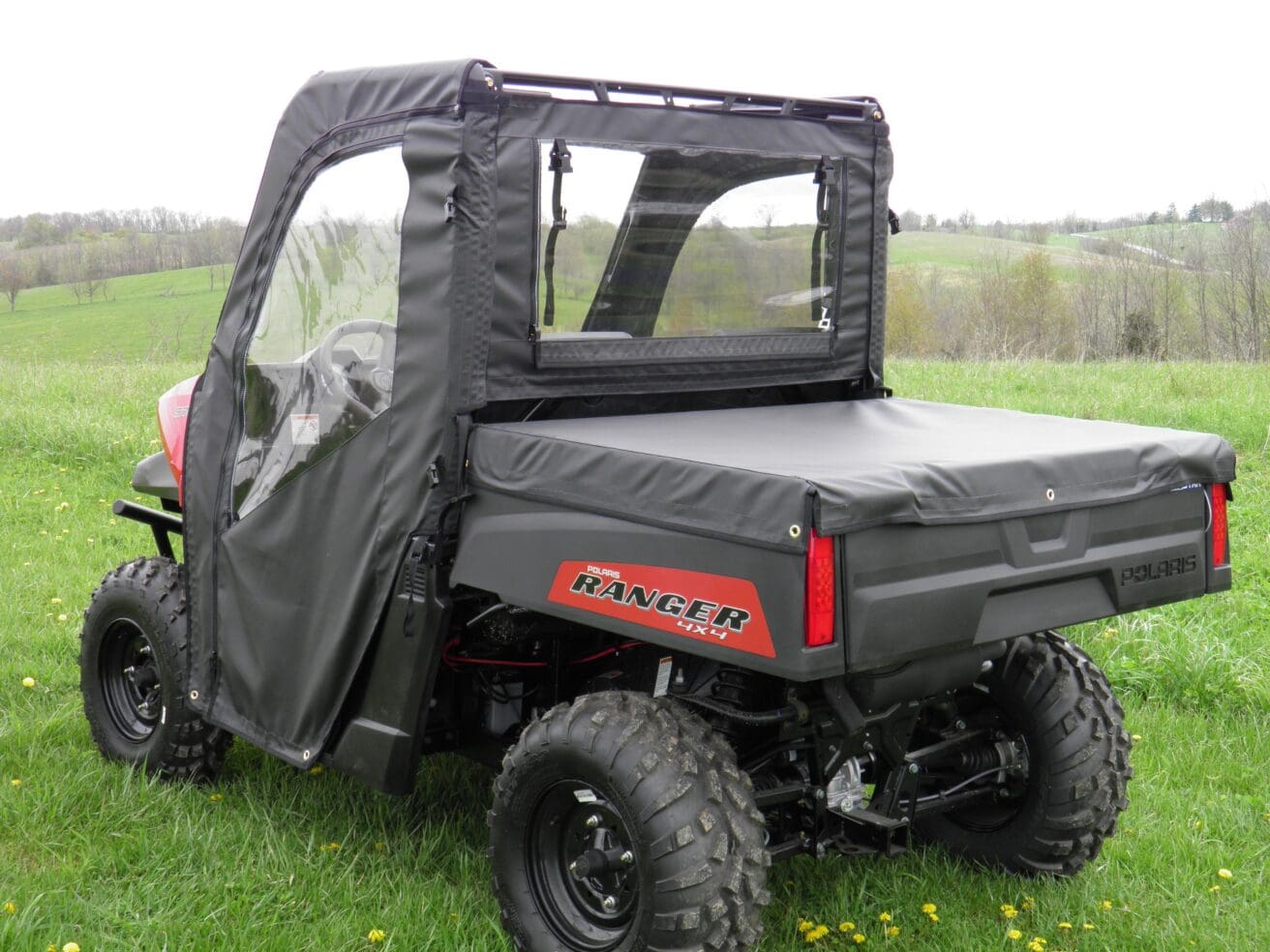 Utility vehicle with clear vinyl enclosure.
