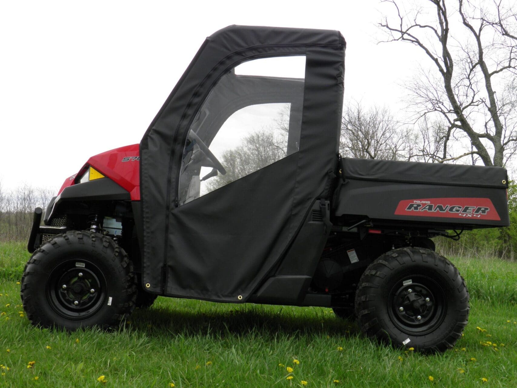 Polaris Ranger UTV with soft enclosure visible.