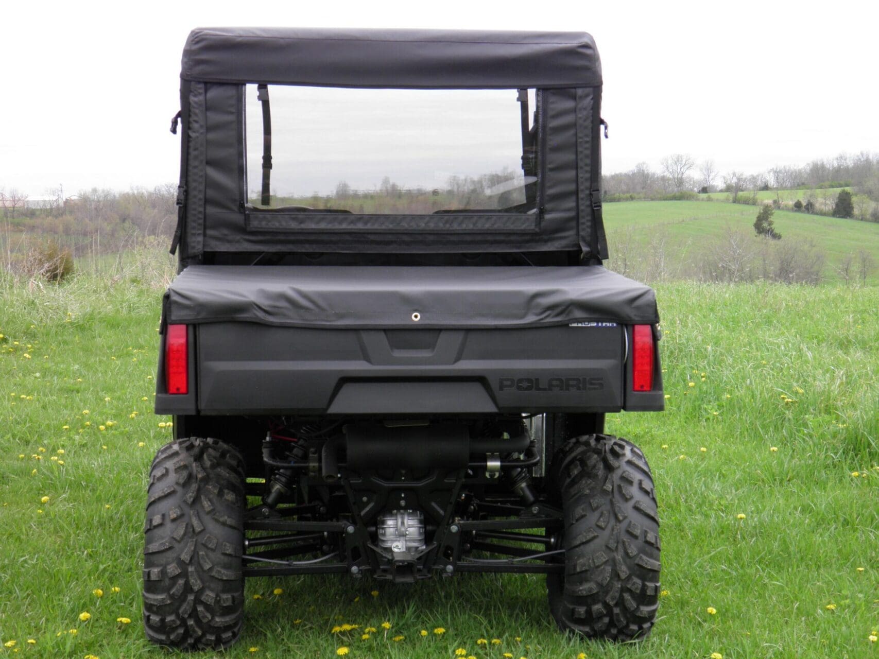 Utility vehicle with soft top and rear window.
