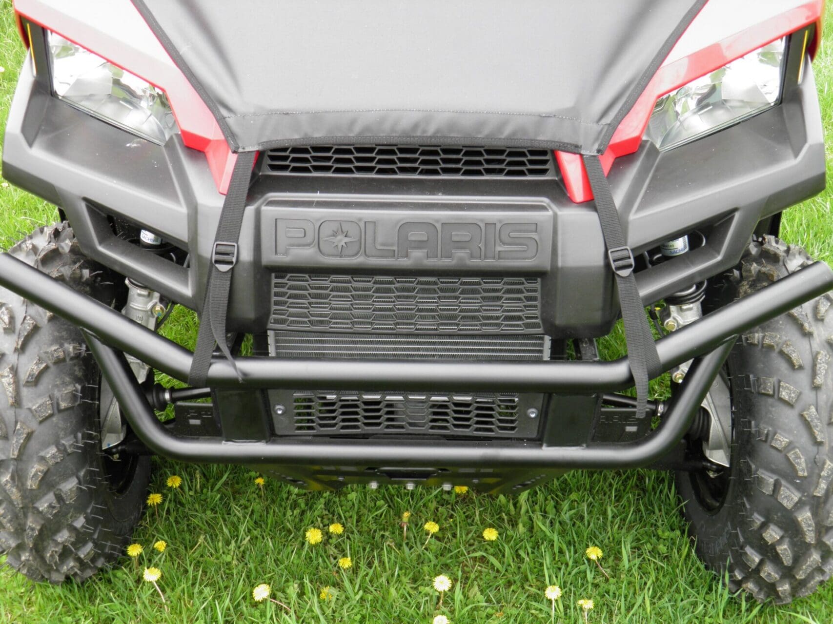 Polaris vehicle front view with protective cover.