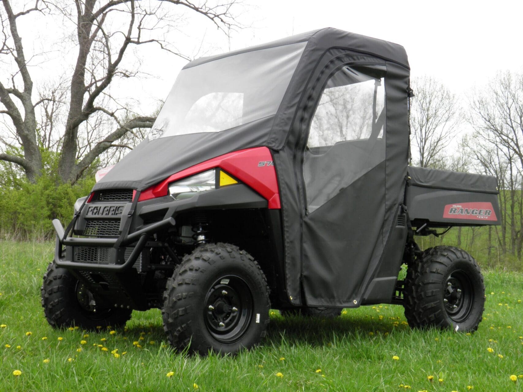 Polaris Ranger with soft cab enclosure outdoors.