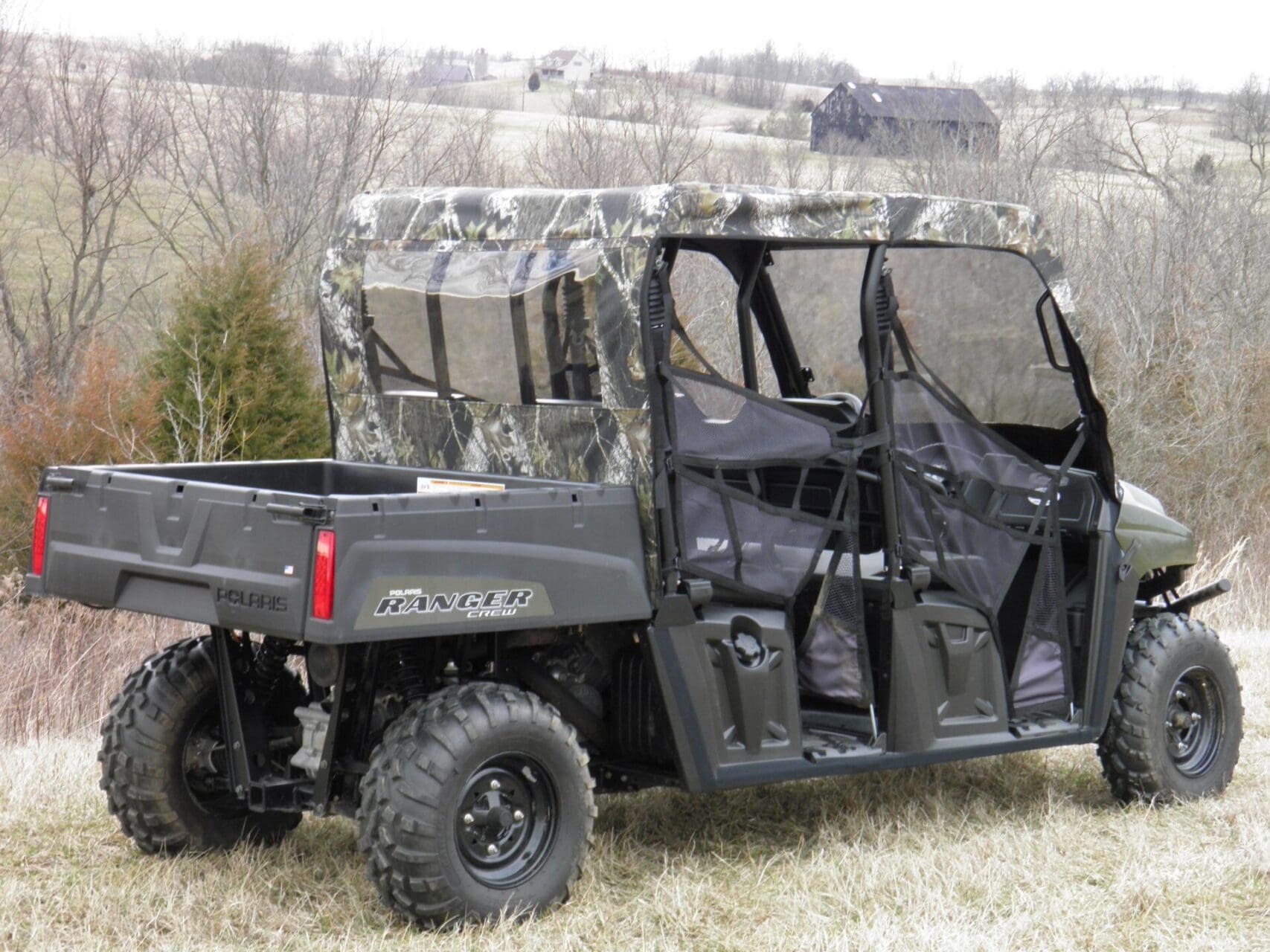 Camouflaged side-by-side UTV parked in field