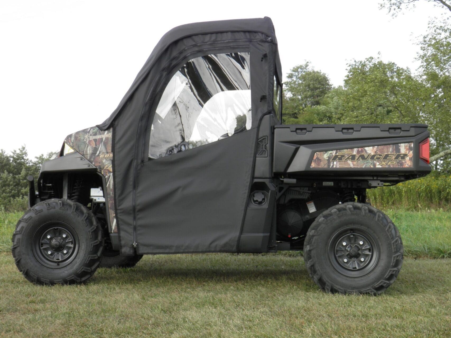 Utility vehicle with camouflage soft enclosure.