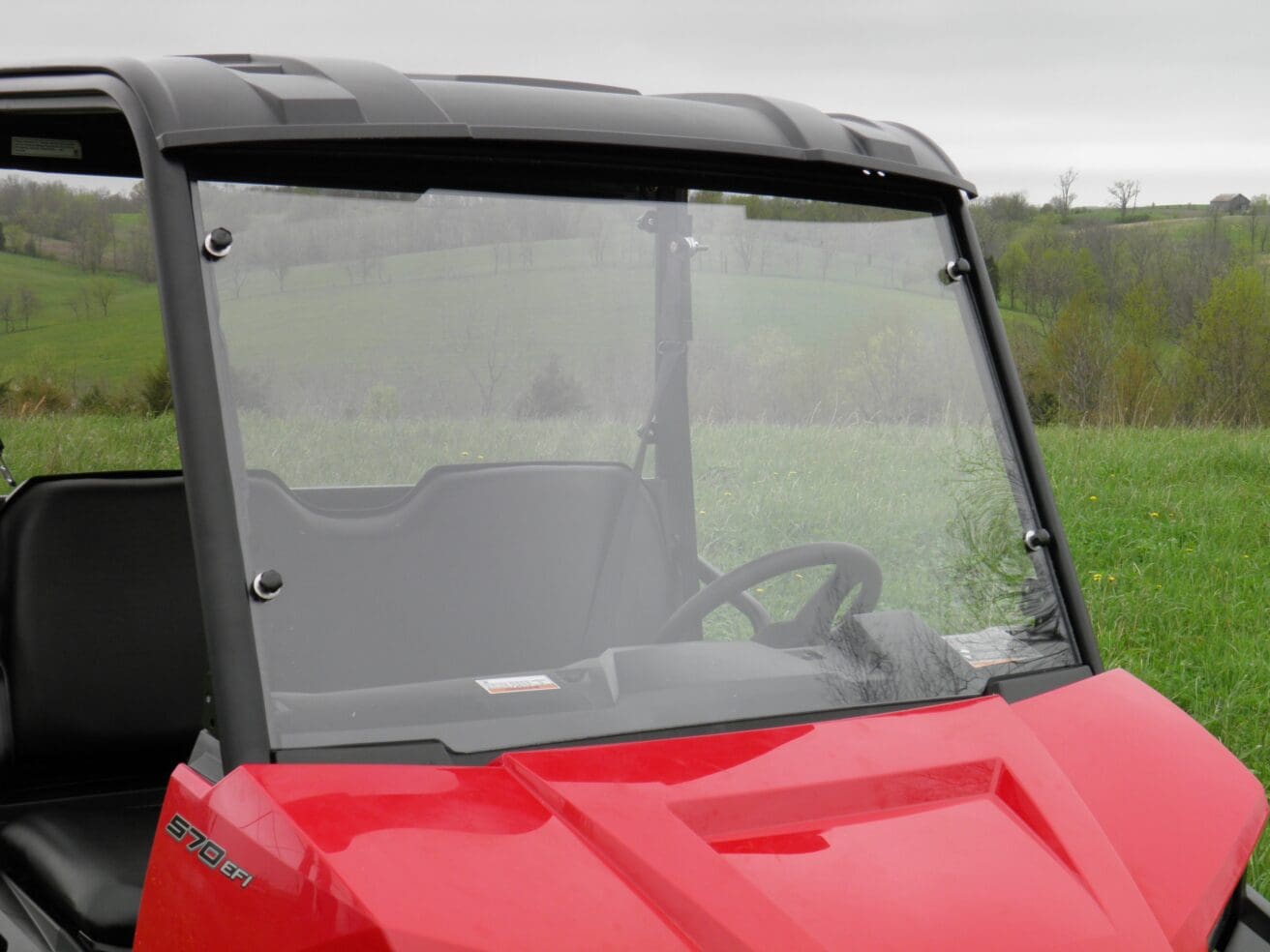 Red off-road side-by-side UTV with windshield