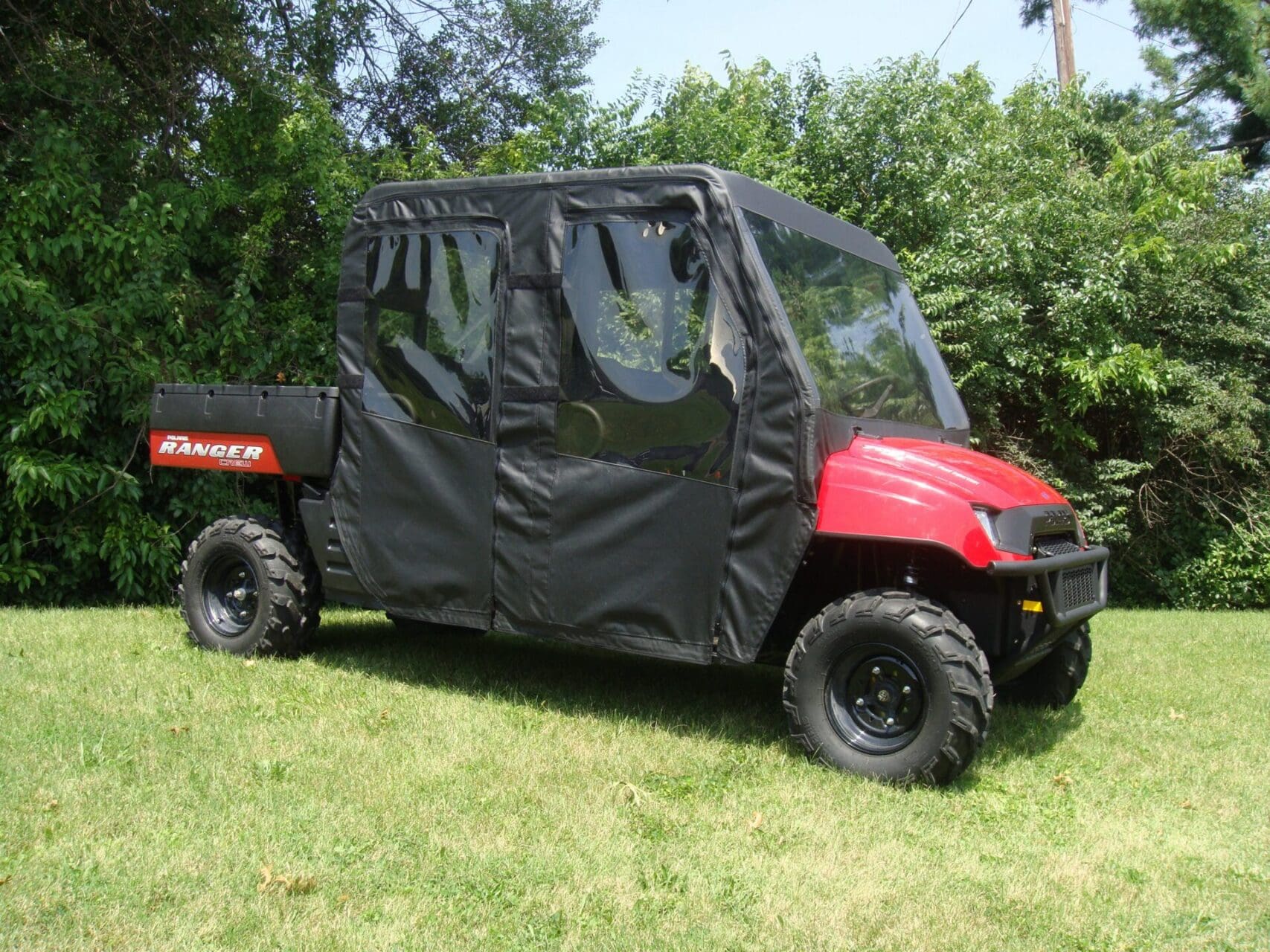 Red UTV with black weather enclosure