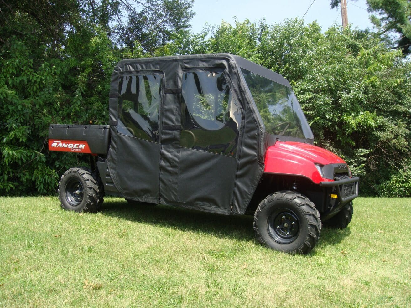 Red utility vehicle with black soft cab enclosure