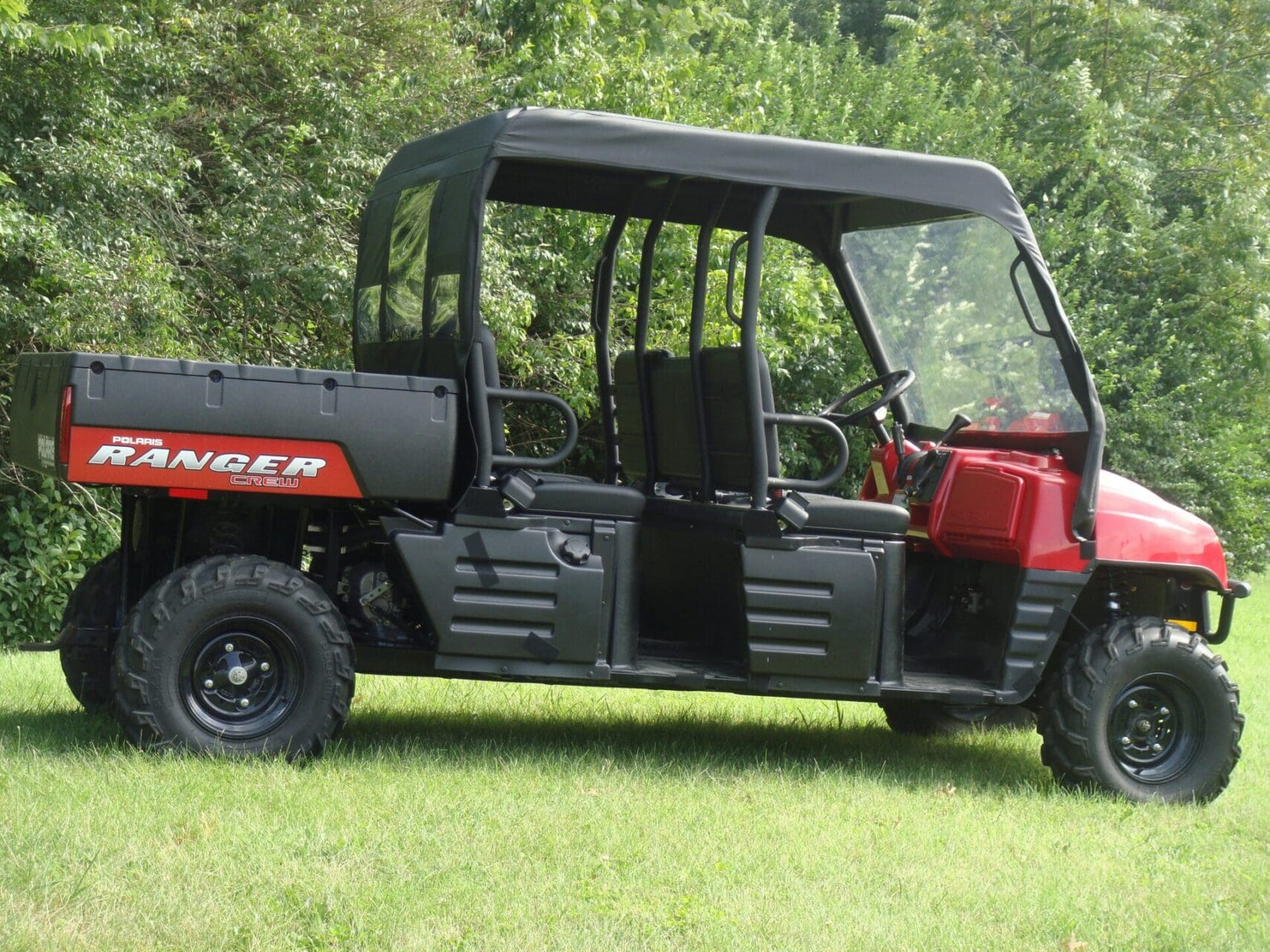 Red utility side-by-side vehicle on grass