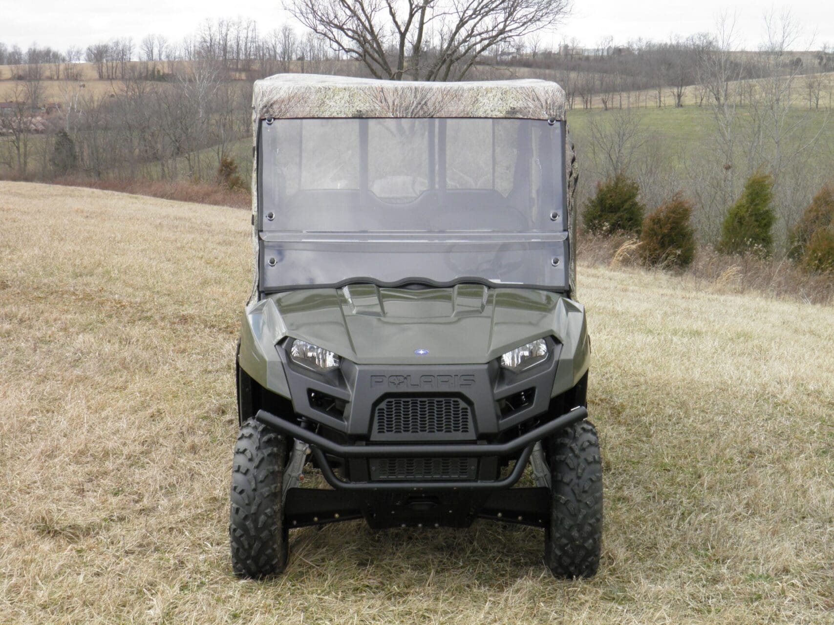 Green off-road utility vehicle in grassy field