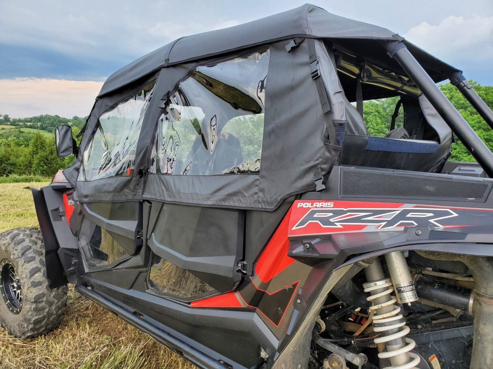 Polaris RZR UTV parked in grassy field