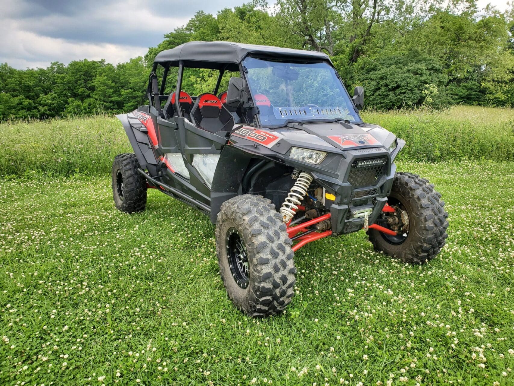 Black and red off-road UTV on grass