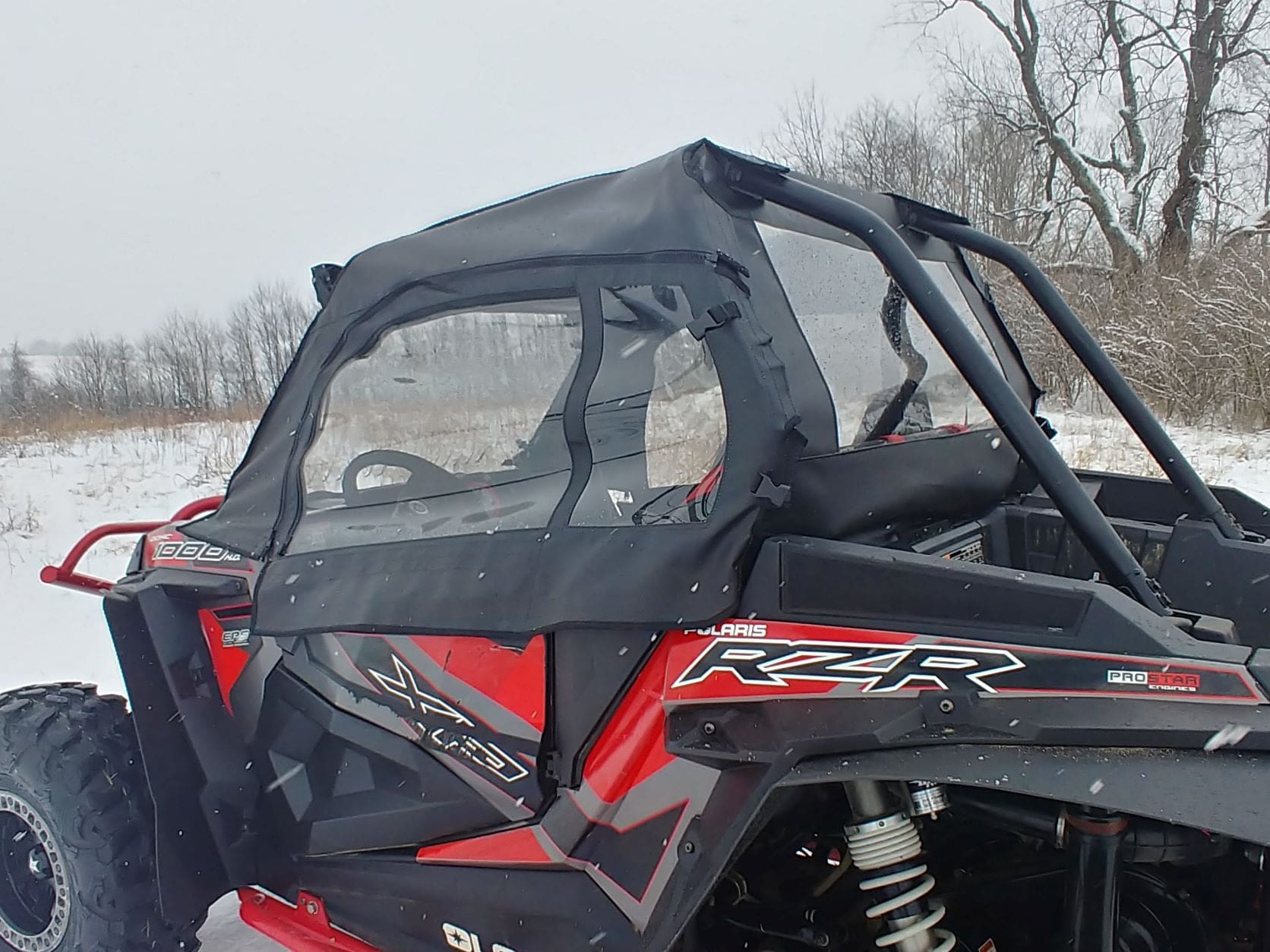 Red Polaris RZR UTV with soft enclosure