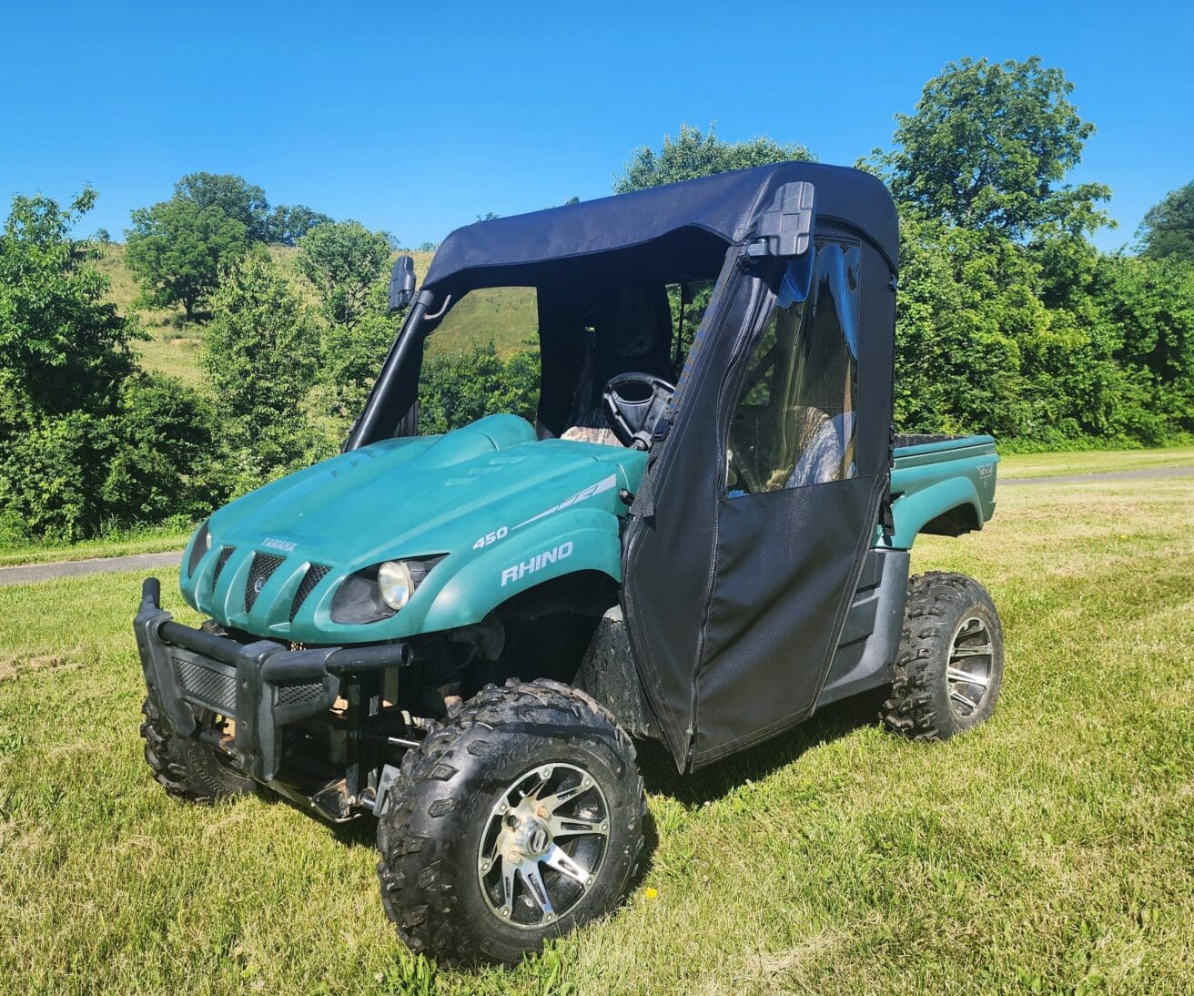 Green utility side-by-side UTV on grass