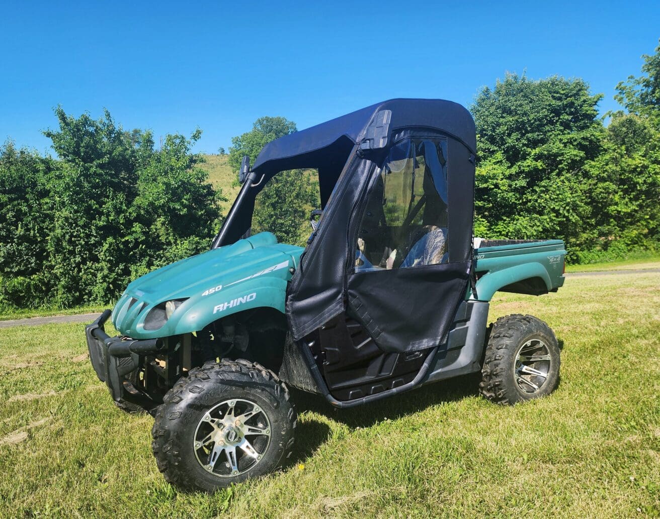 Green side-by-side UTV with soft top
