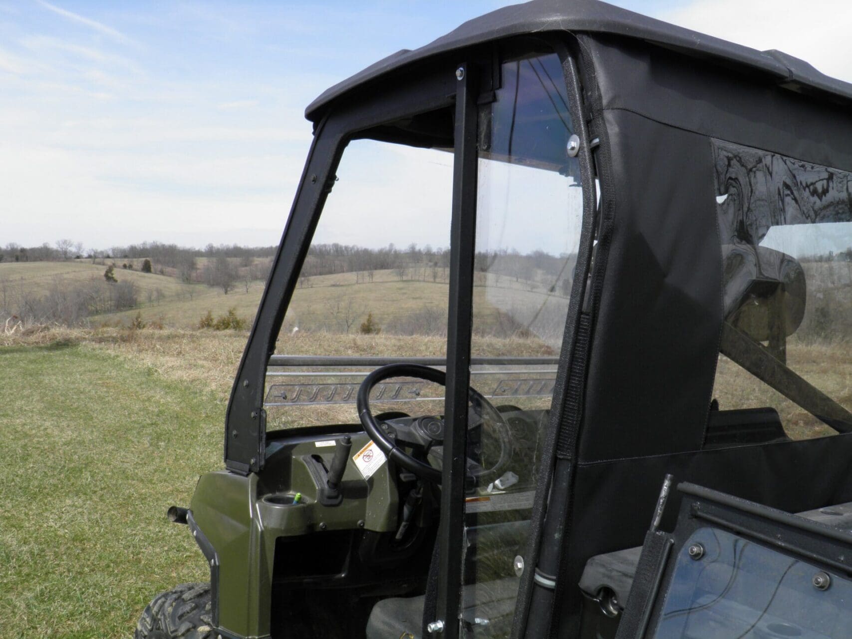 Utility side-by-side vehicle parked on grassy field