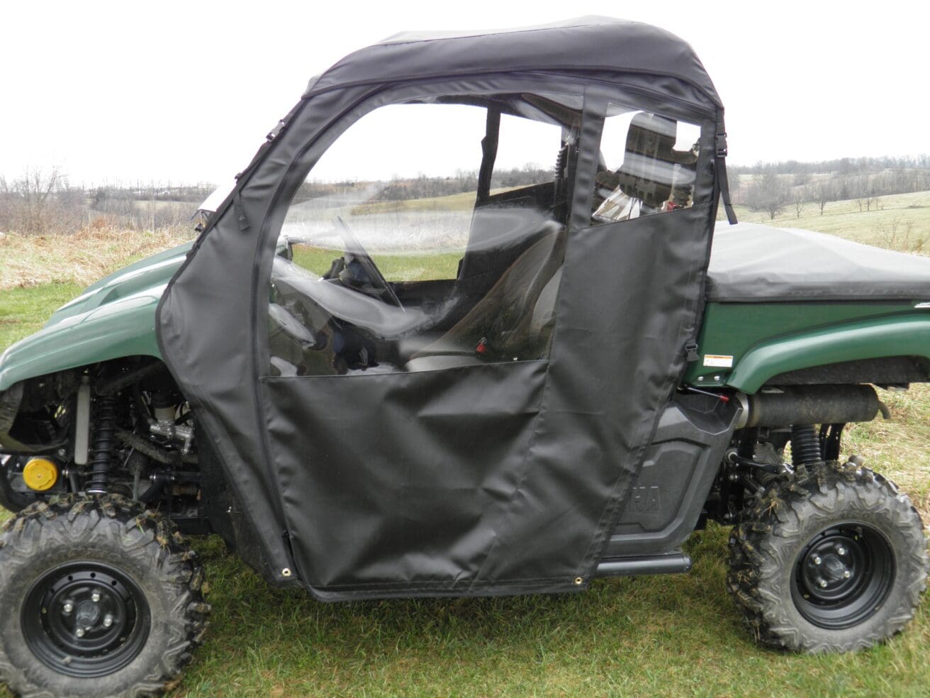 Green UTV with black soft cab enclosure