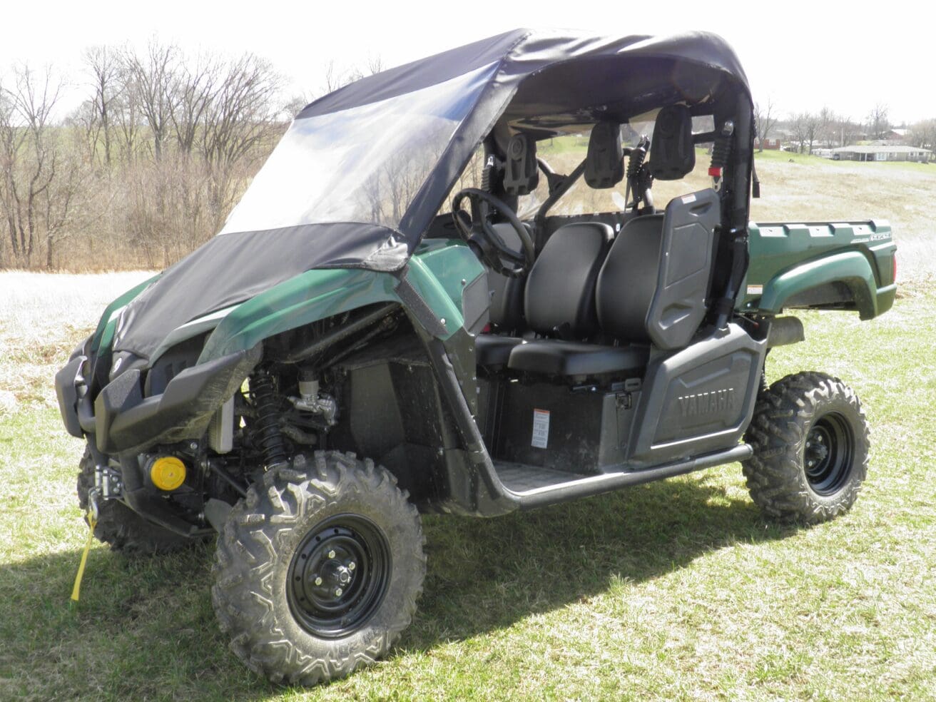 Green side-by-side utility vehicle with canopy
