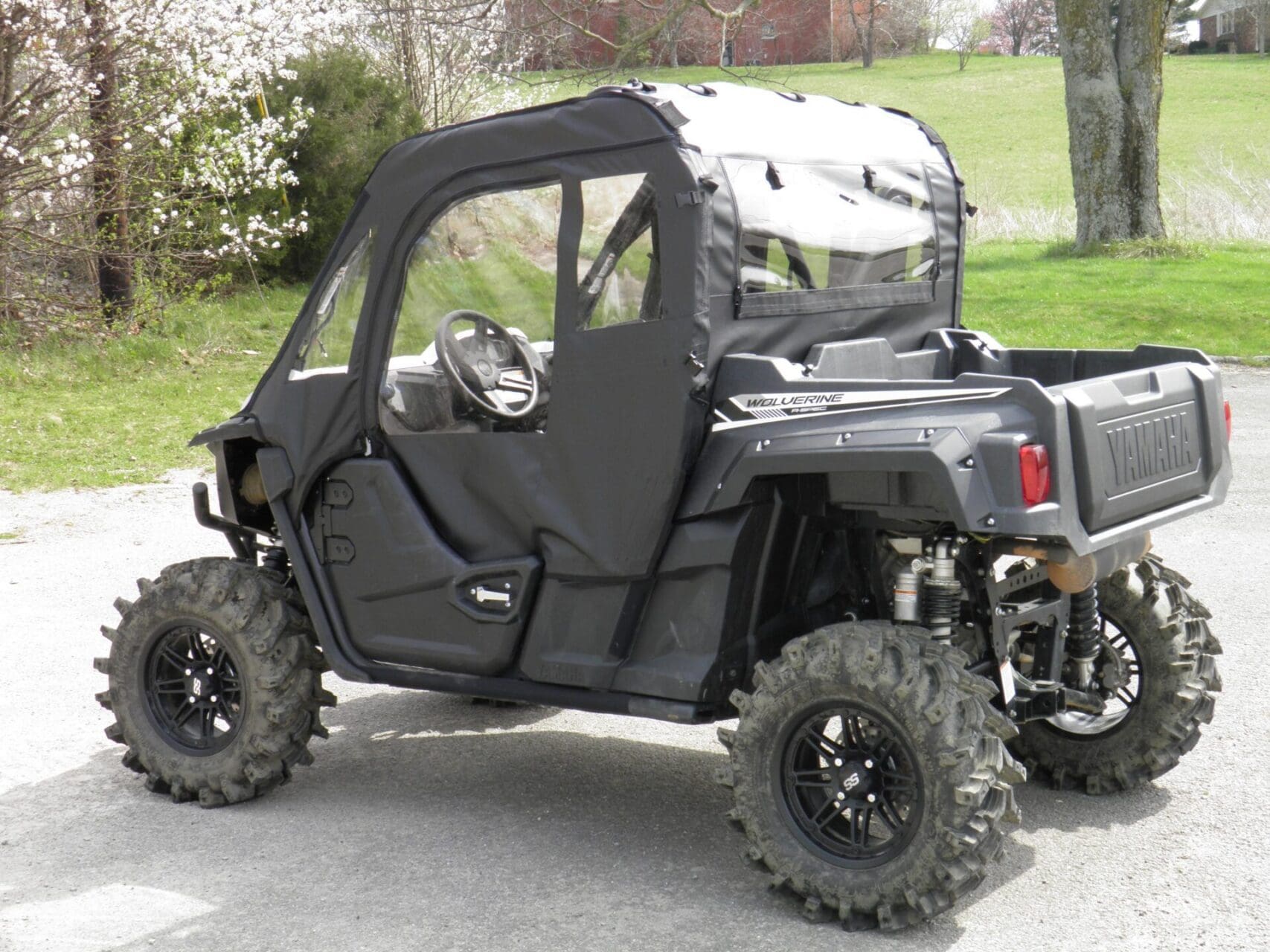 Black side-by-side utility UTV with soft enclosure