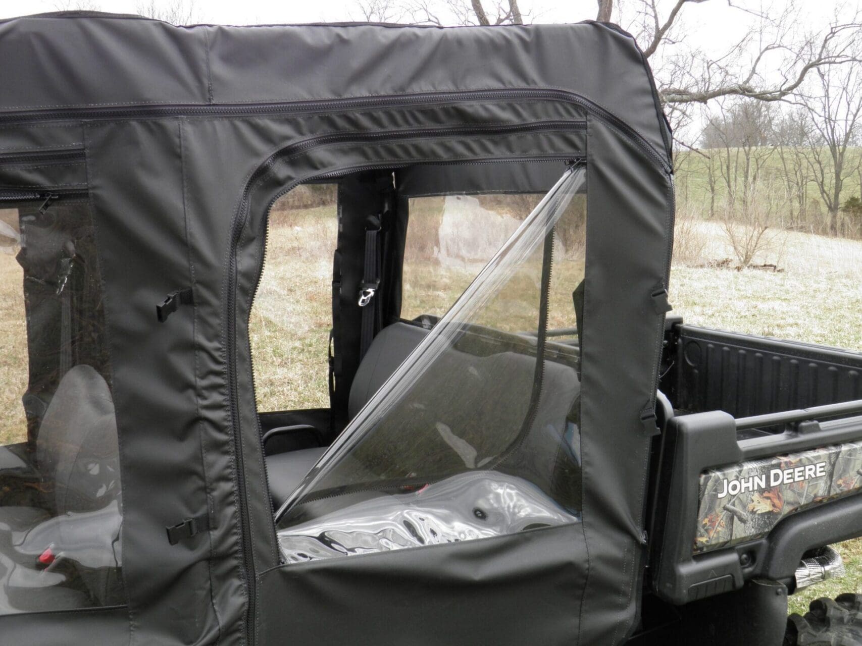John Deere utility vehicle with soft cab enclosure