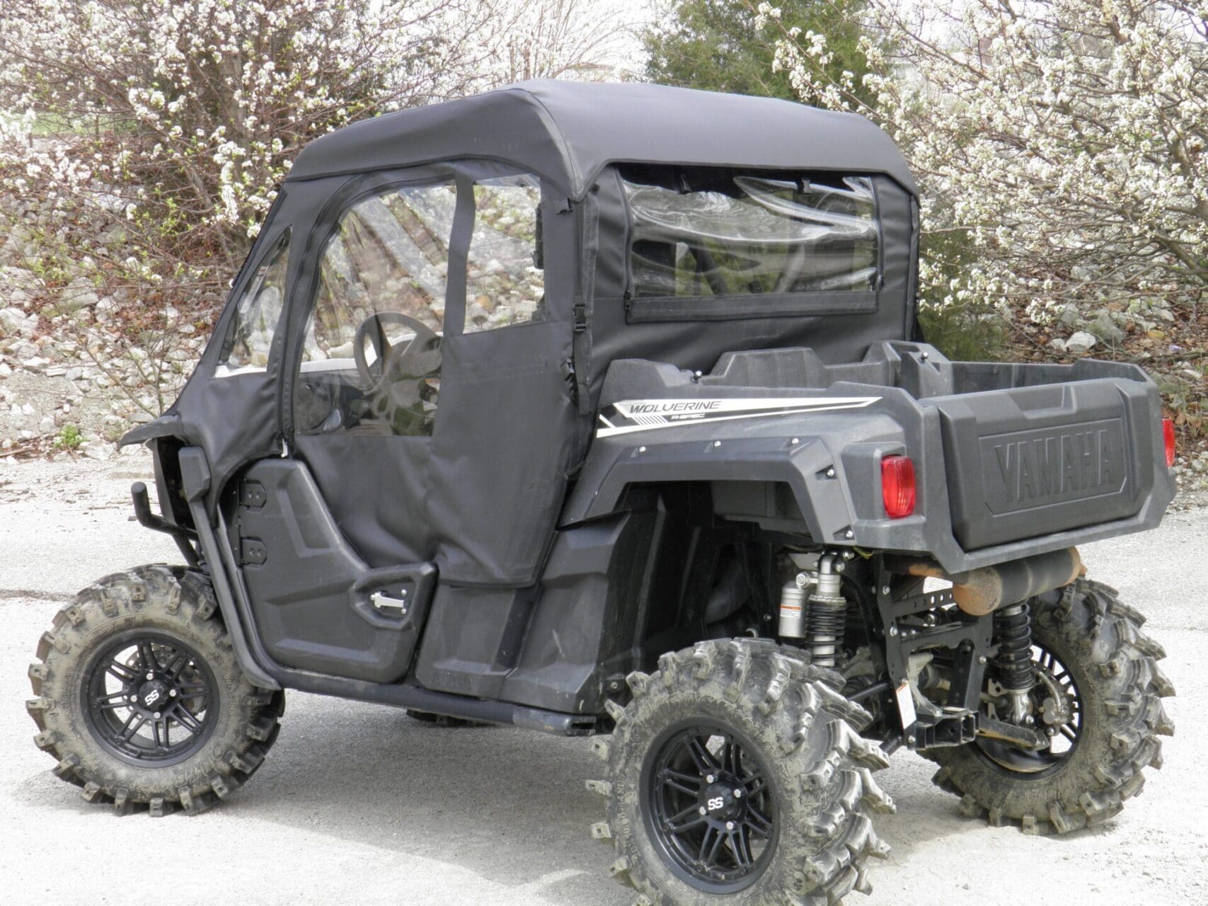 Enclosed black UTV side-by-side with cargo bed