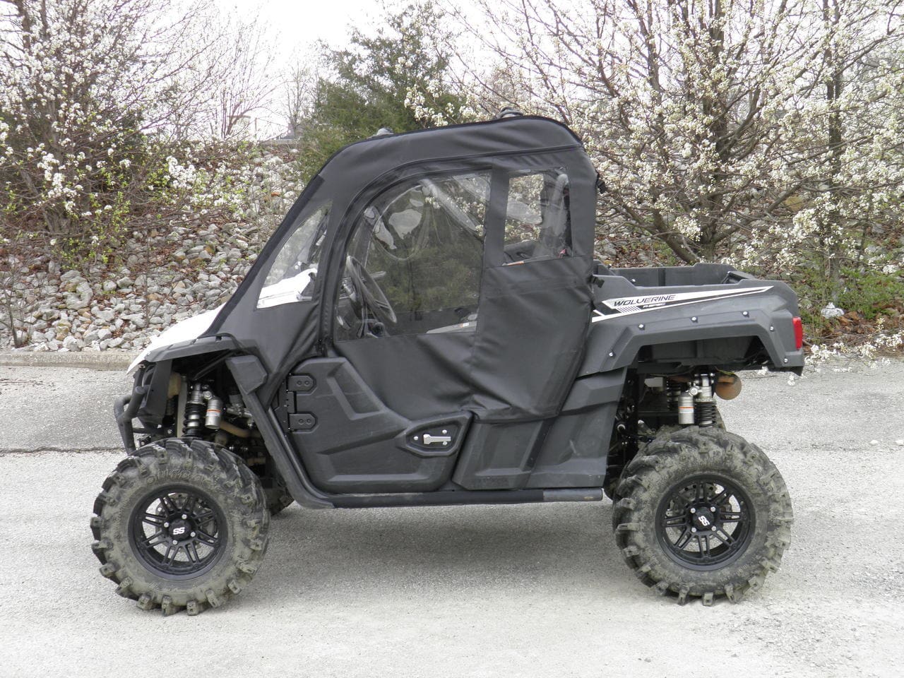 Black side by side UTV with soft enclosure